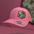 Pink cap with 'American Mama' patch on a pink background