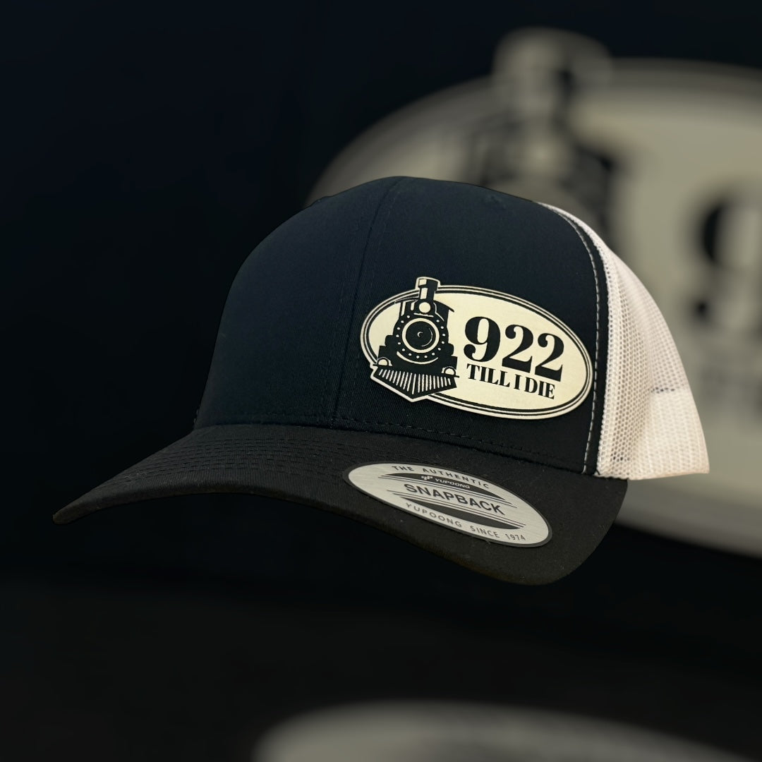 Black and white cap with a logo and text on a dark background