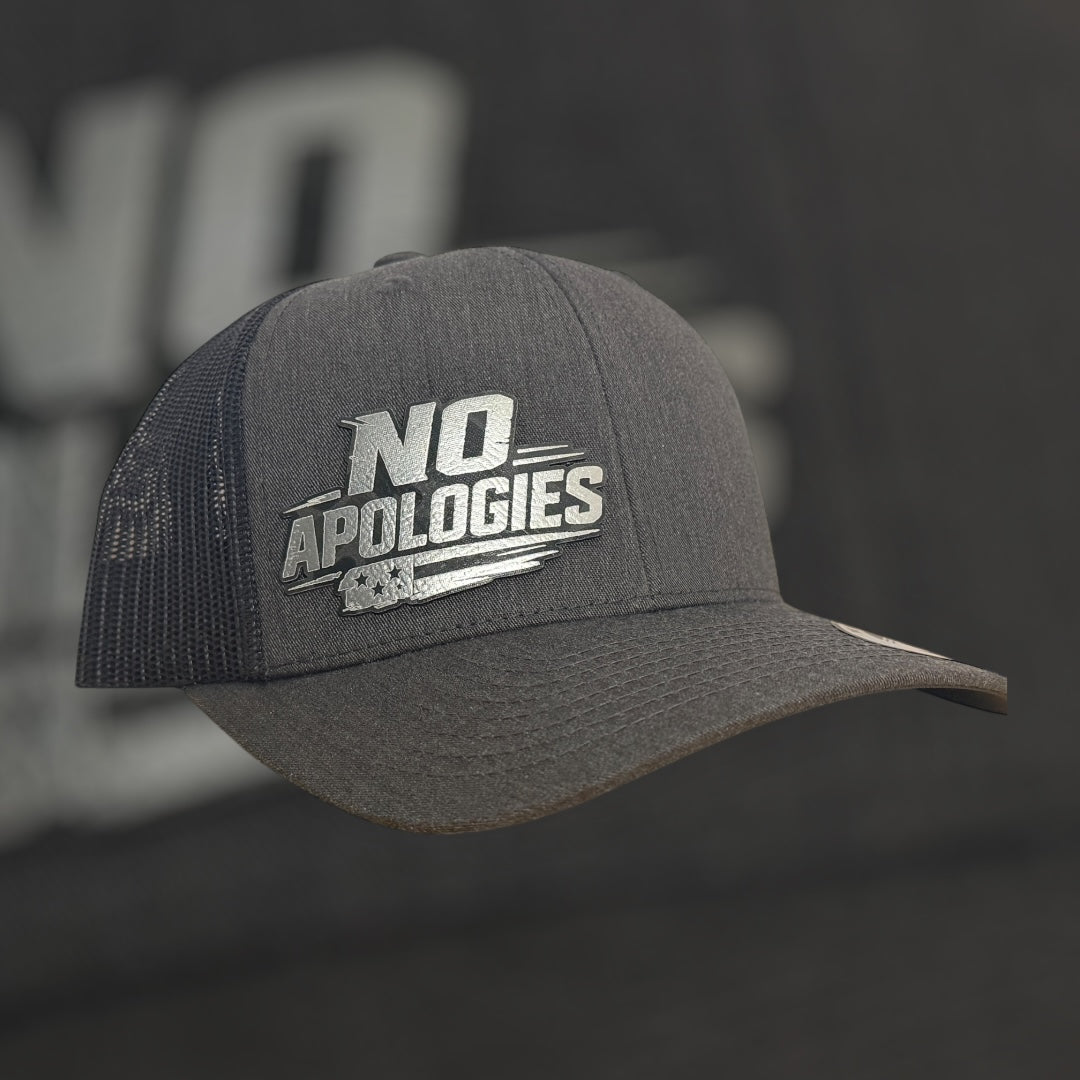 Gray cap with 'NO APOLOGIES' text on a dark background